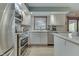 Modern kitchen with stainless steel appliances and white cabinets at 6971 Lynx Dr, Nineveh, IN 46164