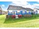 Stunning back exterior showcasing a blue home with a landscaped yard at 3518 Heathcliff Ct, Westfield, IN 46074