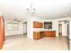 Open kitchen with wood cabinets, tile floor, and stainless steel appliances at 3518 Heathcliff Ct, Westfield, IN 46074