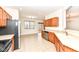 Kitchen with wood cabinets, stainless steel appliances, and tile flooring at 3518 Heathcliff Ct, Westfield, IN 46074