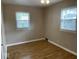 Spacious bedroom with neutral walls and wood-look flooring at 6150 Oak Ave, Indianapolis, IN 46219