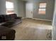 Bright living room featuring light gray walls and wood-look flooring at 6150 Oak Ave, Indianapolis, IN 46219