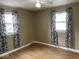 Bedroom with taupe walls, wood-look flooring, and zebra-print curtains at 6150 Oak Ave, Indianapolis, IN 46219