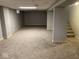 Unfinished basement with gray walls and neutral carpeting at 6150 Oak Ave, Indianapolis, IN 46219