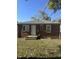 Brick home with a white door and a spacious backyard at 4529 Crittenden Ave, Indianapolis, IN 46205