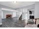 Spacious living room featuring hardwood floors and a brick fireplace at 3616 N College Ave, Indianapolis, IN 46205