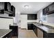 Modern kitchen with dark cabinets, granite countertops, and stainless steel appliances at 3616 N College Ave, Indianapolis, IN 46205