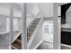 Modern staircase with white railing and dark hardwood floors at 3616 N College Ave, Indianapolis, IN 46205