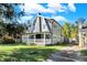 Gray sided two-story house with white porch and driveway at 3616 N College Ave, Indianapolis, IN 46205