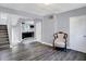 Bright living room with hardwood floors, fireplace, and kitchen view at 3616 N College Ave, Indianapolis, IN 46205