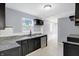 Modern kitchen with dark cabinets, granite counters, and stainless steel appliances at 3616 N College Ave, Indianapolis, IN 46205