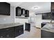 Modern kitchen with dark cabinets, granite countertops, and stainless steel appliances at 3616 N College Ave, Indianapolis, IN 46205