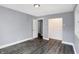 Spacious bedroom with grey walls and wood-look flooring at 3616 N College Ave, Indianapolis, IN 46205
