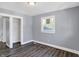 Spacious bedroom with grey walls, wood flooring, and closet at 3616 N College Ave, Indianapolis, IN 46205