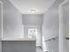 Bright staircase with grey walls and a small window at 3616 N College Ave, Indianapolis, IN 46205