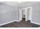 Spacious bedroom with grey walls, wood-look flooring, and ample closet space at 3616 N College Ave, Indianapolis, IN 46205