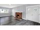 Living room featuring a brick fireplace and hardwood floors at 3616 N College Ave, Indianapolis, IN 46205