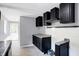 Modern kitchen with dark cabinets, granite counters, and stainless steel appliances at 3616 N College Ave, Indianapolis, IN 46205