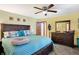 Main bedroom with king bed, dresser, and ceiling fan at 2674 E Cottonwood Trl, Morristown, IN 46161