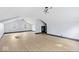 Spacious bonus room with light hardwood floors and modern light fixtures at 3752 Ruckle St, Indianapolis, IN 46205
