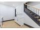 Kitchen with white cabinets, staircase, and quartz countertops at 3752 Ruckle St, Indianapolis, IN 46205