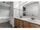 Double vanity bathroom with a large mirror and modern fixtures at 19420 Golden Meadow Way, Noblesville, IN 46060