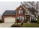 Brick house with two-car garage and landscaping at 19420 Golden Meadow Way, Noblesville, IN 46060