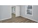 Bedroom with wood-look flooring and access to another room at 1327 N Gale St, Indianapolis, IN 46201