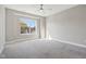 Bright bedroom with large window, ceiling fan, and grey carpeting at 1817 N New Jersey St, Indianapolis, IN 46202