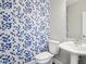Powder room with pedestal sink and blue floral wallpaper at 1817 N New Jersey St, Indianapolis, IN 46202