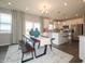 Modern dining room with a long wooden table and kitchen view at 236 Sam Himsel Way, Danville, IN 46122