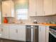 White kitchen with stainless steel appliances and corner sink at 236 Sam Himsel Way, Danville, IN 46122