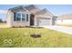 New construction home with a two-car garage and tree at 2298 Pine Valley Dr, Plainfield, IN 46168