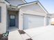 Three-car garage with light gray doors and brick exterior at 2298 Pine Valley Dr, Plainfield, IN 46168