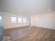 Large living area with wood-look floors and windows at 2298 Pine Valley Dr, Plainfield, IN 46168