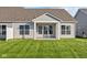 House with covered patio and grassy backyard at 10549 Maidenhair Dr, Indianapolis, IN 46239