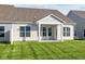 House with covered patio and grassy backyard at 10549 Maidenhair Dr, Indianapolis, IN 46239