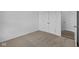 Well-lit bedroom featuring double door closet and neutral carpeting at 10549 Maidenhair Dr, Indianapolis, IN 46239