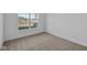 Spacious bedroom with neutral carpeting and a large window at 10549 Maidenhair Dr, Indianapolis, IN 46239