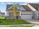 Gray siding craftsman style home with two-car garage and stone accents at 10549 Maidenhair Dr, Indianapolis, IN 46239
