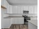 Modern kitchen with white cabinets and stainless steel appliances at 10549 Maidenhair Dr, Indianapolis, IN 46239