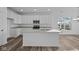 Modern kitchen featuring white cabinets, stainless steel appliances and an island at 10549 Maidenhair Dr, Indianapolis, IN 46239