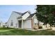 Brick and white side exterior of charming ranch home with landscaped yard at 1202 Creek Bend Dr, Greenwood, IN 46143