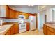 Well-equipped kitchen with oak cabinets and white appliances at 1202 Creek Bend Dr, Greenwood, IN 46143