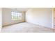 Simple bedroom with large window and neutral walls at 1202 Creek Bend Dr, Greenwood, IN 46143