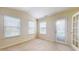 Sun-filled sunroom with multiple windows and door access at 1202 Creek Bend Dr, Greenwood, IN 46143