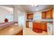 Kitchen with oak cabinets, white appliances, and breakfast bar at 1202 Creek Bend Dr, Greenwood, IN 46143