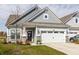 Gray siding, white garage door, stone accents, and landscaping at 6529 Amber Ct, Whitestown, IN 46075