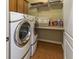 Bright laundry room with washer, dryer, and ample shelving at 236 N Liberty Blvd, Mooresville, IN 46158