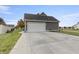 Attached garage with large door and concrete driveway at 236 N Liberty Blvd, Mooresville, IN 46158